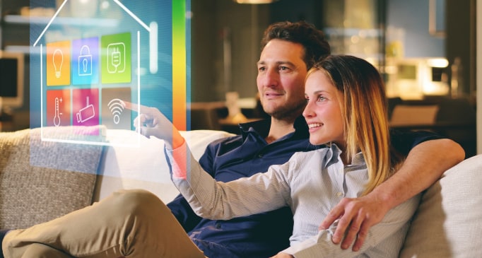 A couple at home looking at a virtual representation of home automation