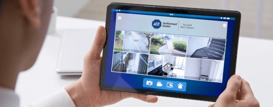Homeowner checking out camera footage on a tablet